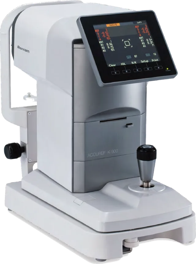 The autorefractor used here: a chinrest and forehead bar on the patient's side, a measuring head above them, and a screen facing the examiner.